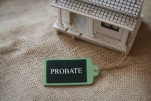 a toy house on a rug with a tag that says probate